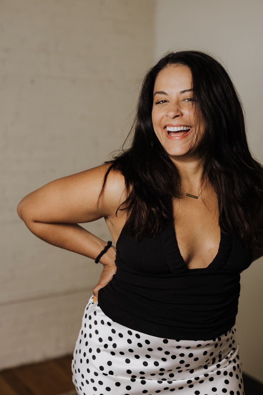 Mel laughing, hand on her hip