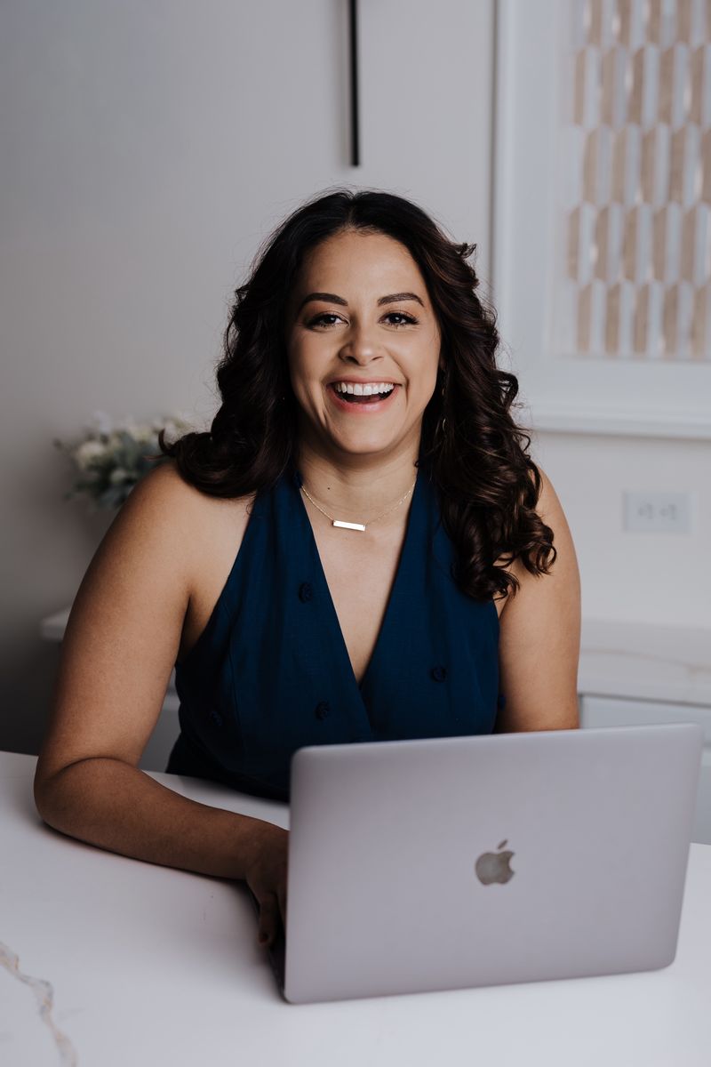 Mel smiling at her laptop